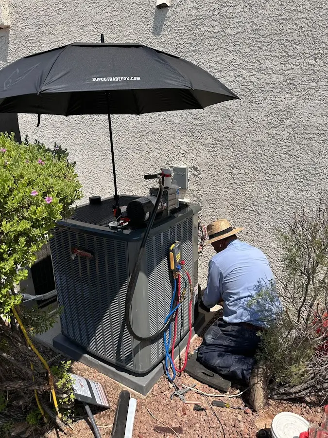 HVAC technician performing outdoor AC maintenance in Rochester
